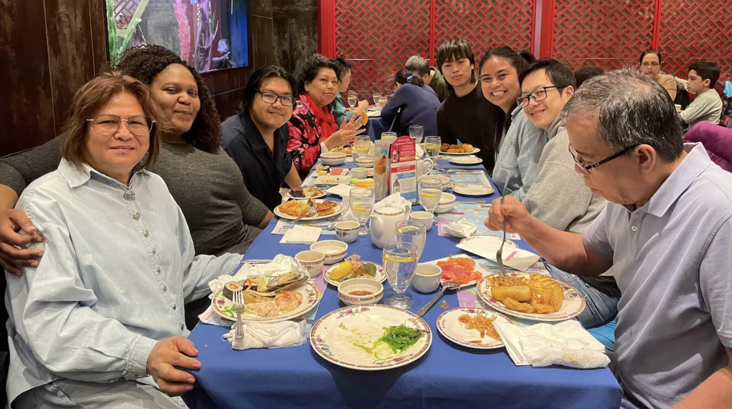 A group sharing a meal around a restaurant table.