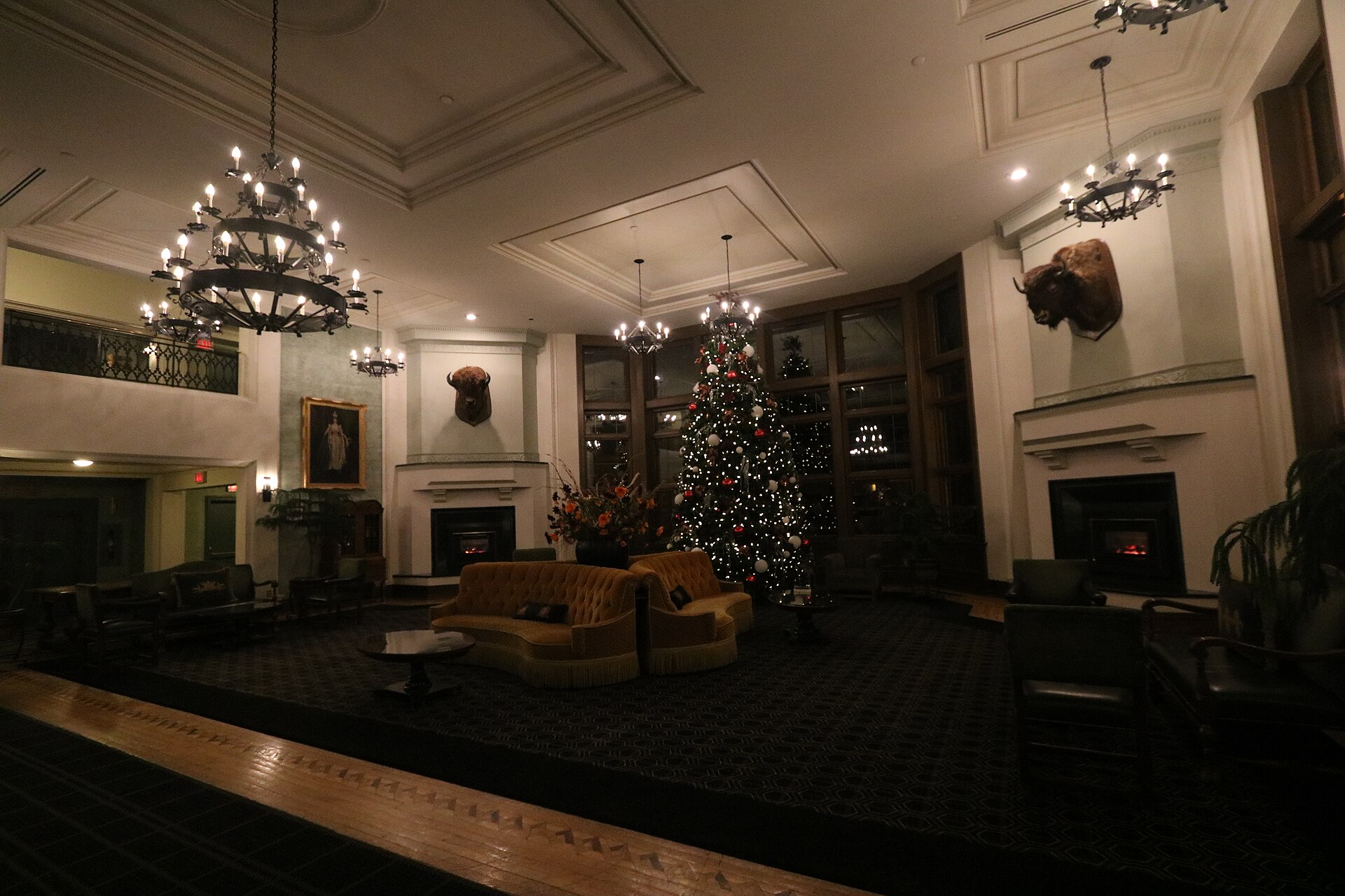 Lobby of the Banff Springs Hotel, with chandeliers, fireplaces and a decorated Christmas tree.